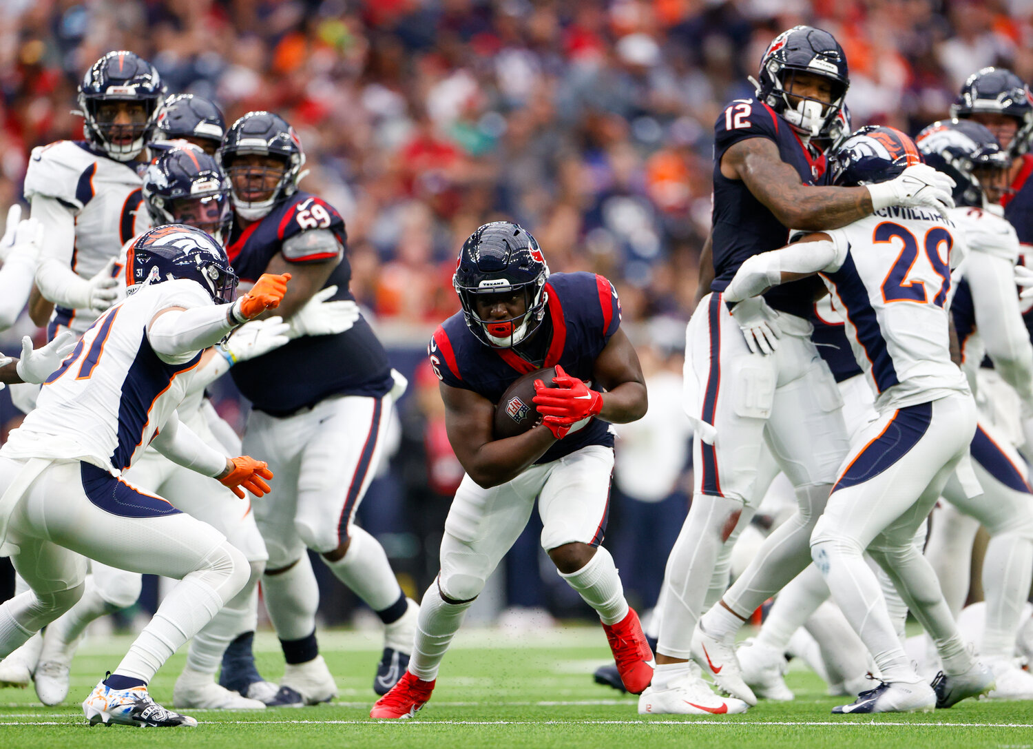 Texans running back Devin Singletary (26) carries the ball during an NFL game between the Texans and the Broncos on December 3, 2023 in Houston. The Texans won, 22-17.