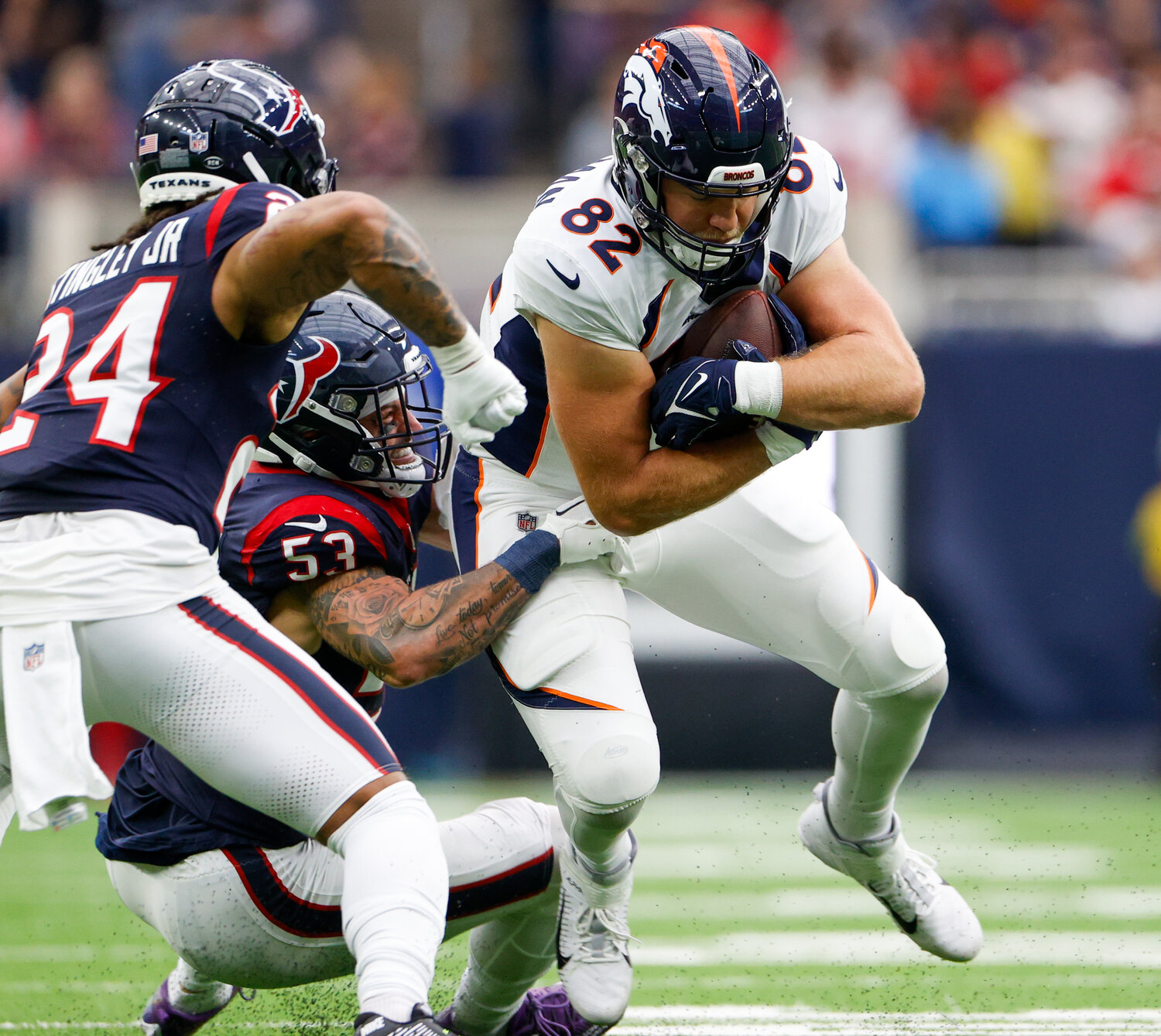 Texans linebacker Blake Cashman (53) tackles Broncos tight end Adam Trautman (82) during an NFL game on December 3, 2023 in Houston. The Texans won, 22-17.