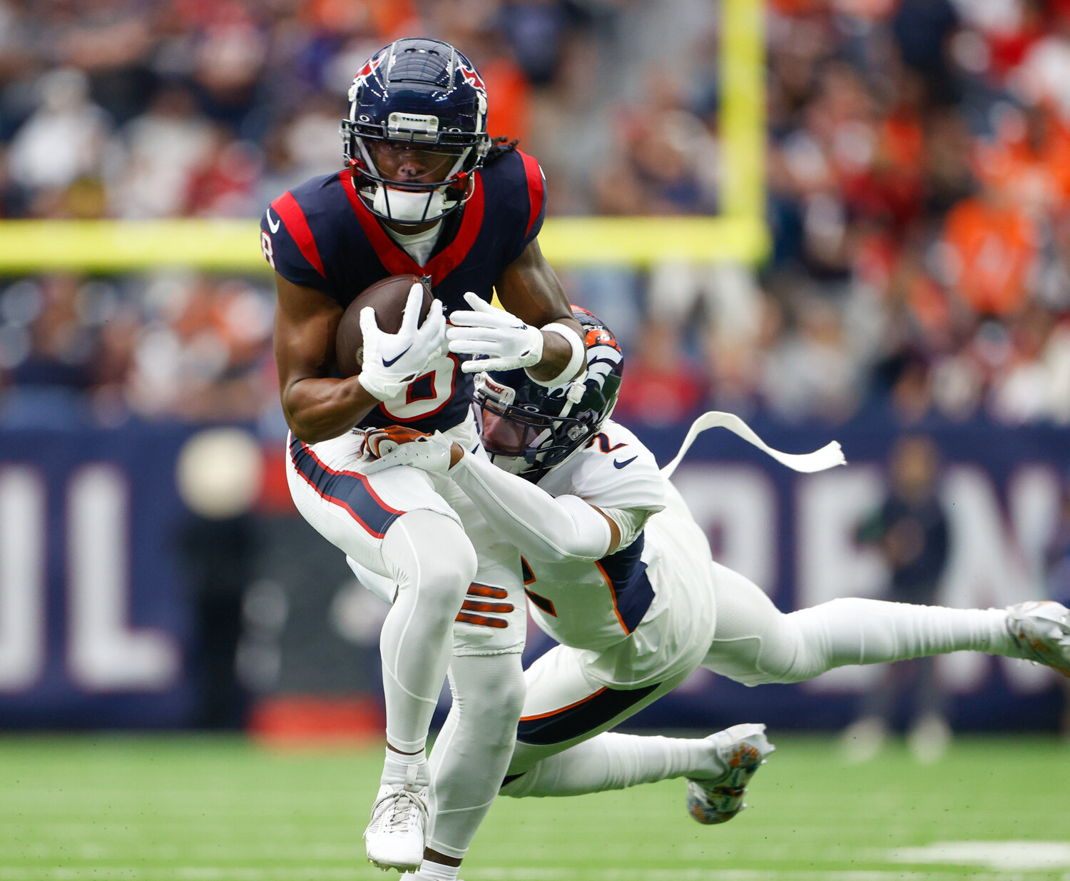 Texans wide receiver John Metchie III (8) is tackled after a catch during an NFL game between the Texans and the Broncos on December 3, 2023 in Houston. The Texans won, 22-17.