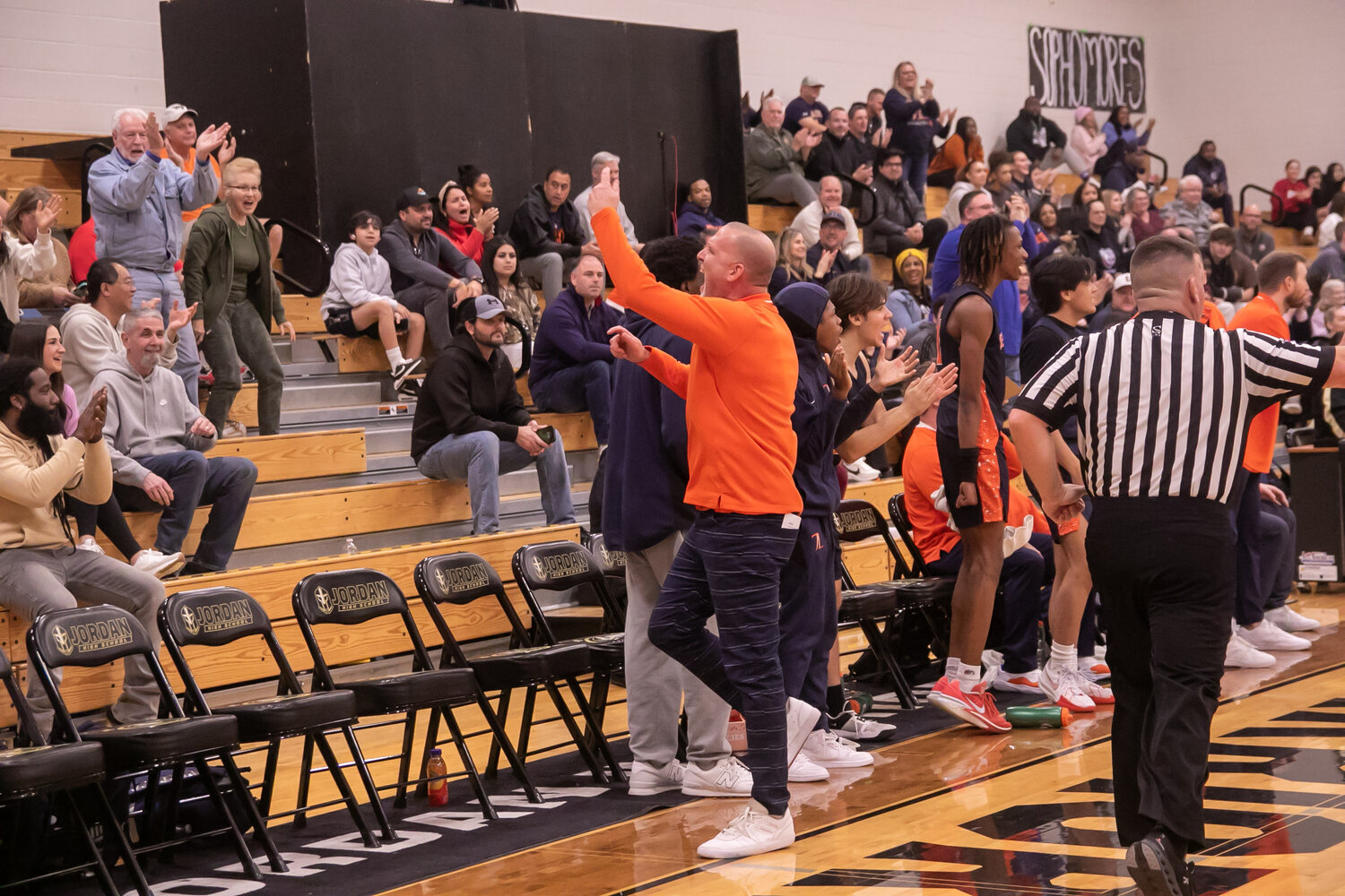 Seven Lakes head coach Shannon Heston cheers towards the crowd during Saturday's game between Seven lakes and Jordan at the Jordan gym.