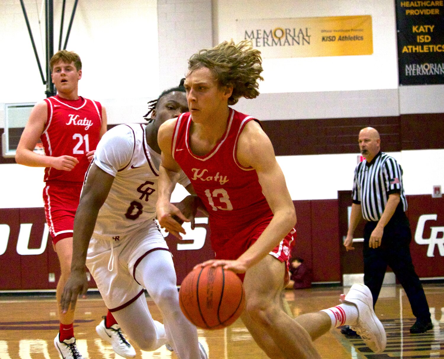 Thomas Belaiter drives to the basket during Wednesday’s game between Katy and Cinco Ranch at the Cinco Ranch gym.