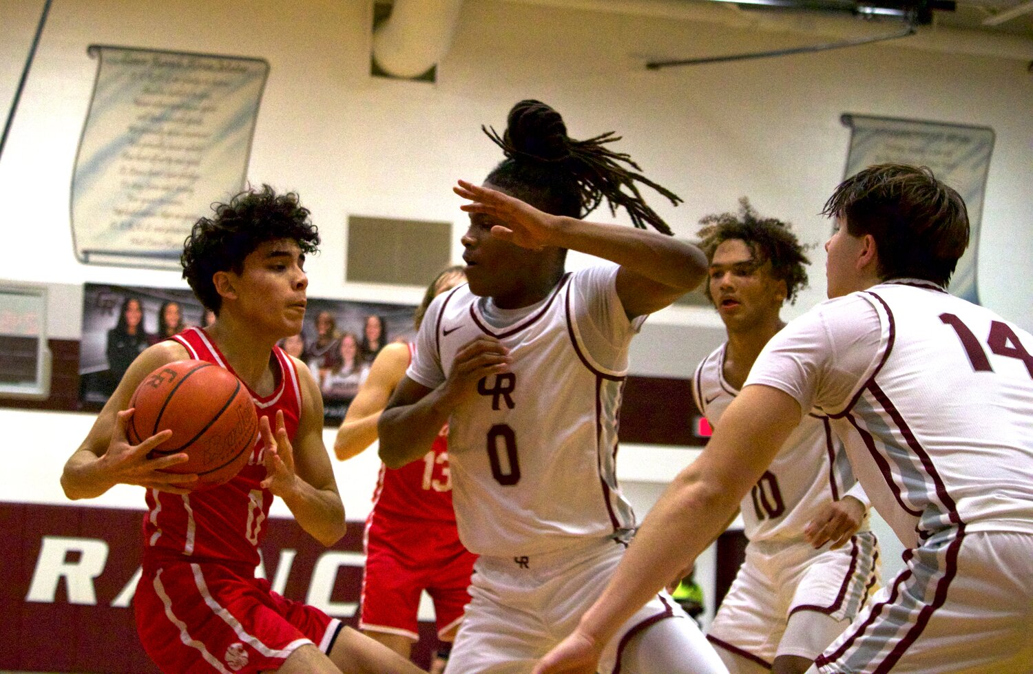 Greg Santos drives and looks for a teammate during Wednesday’s game between Katy and Cinco Ranch at the Cinco Ranch gym.