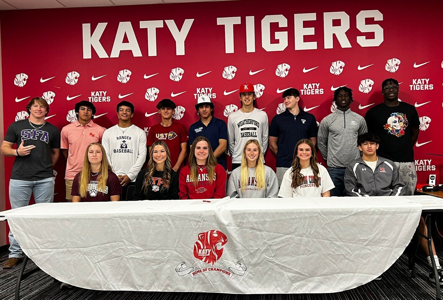 Katy student-athletes pose for a photo during the signing ceremony at Katy High School.