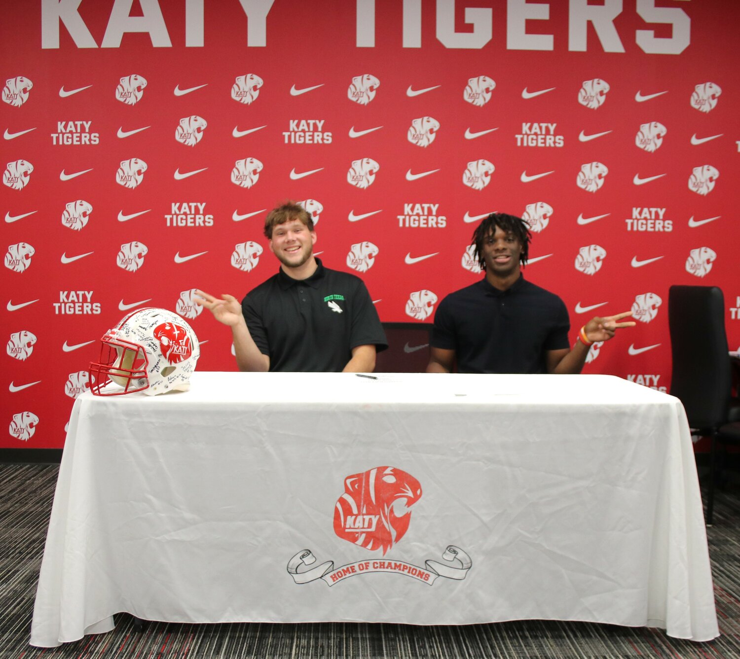 Luke Carter and Dakyus Brinkley pose for a photo during the signing ceremony at Katy High School.