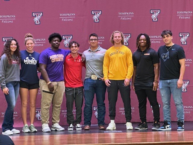 Tompkins student athletes pose for a photo during the signing ceremony at Tompkins High School.