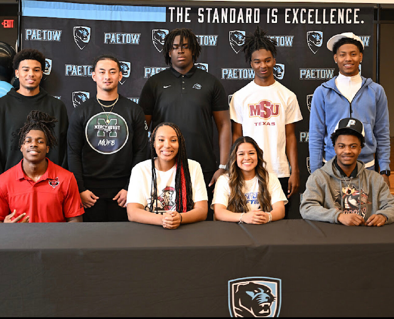 Paetow student athletes pose for a photo during the signing ceremony at Paetow High School.