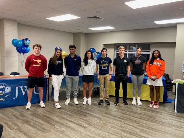 Seven Lakes student athletes pose for a photo during the signing ceremony at Seven Lakes High School.